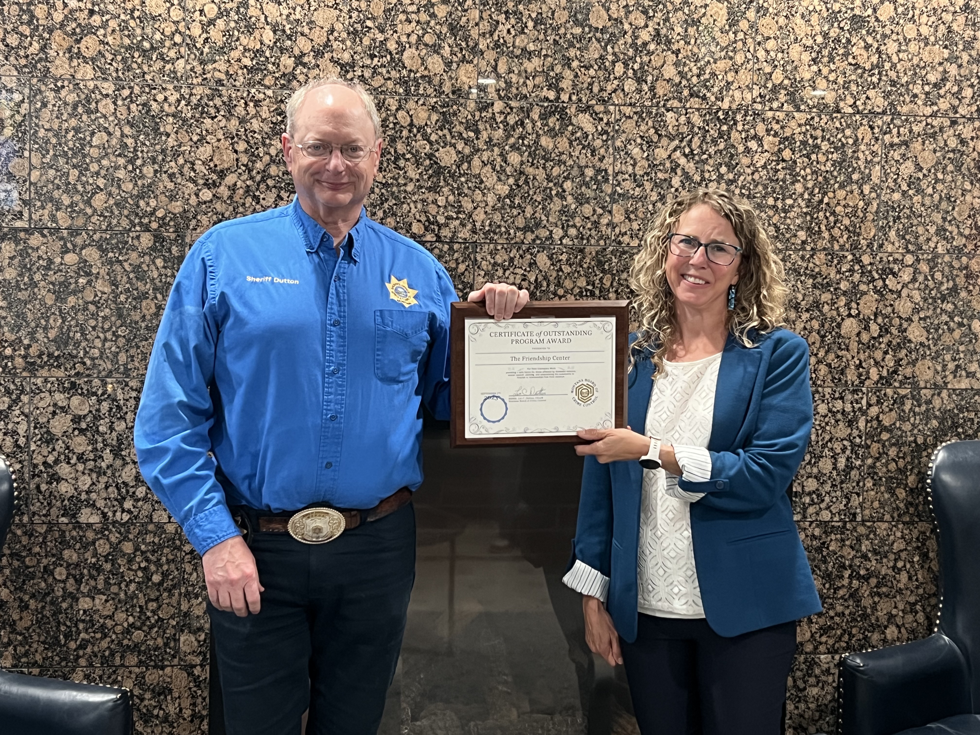 MBCC Chairman Leo Dutton presents Kim Patterson, Development Direct at The Friendship Center, with the Certificate of Outstanding Program Award at the 2023 September Board Meeting at the Calvert Hotel in Lewistown, MT.